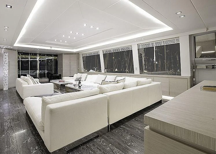 a large living room with white couches aboard SEAFIRE Yacht for Sale