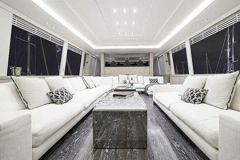a room with white couches and a coffee table aboard SEAFIRE Yacht for Sale