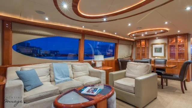a living room with a large blue screen aboard CHIP Yacht for Sale