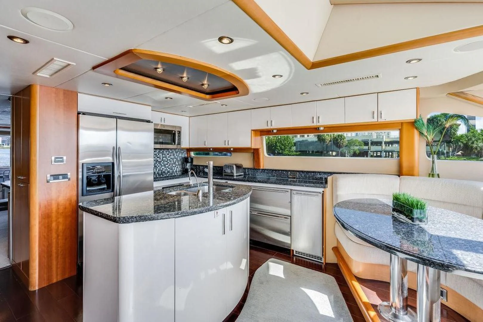 a kitchen with a table and a bar aboard CHIP Yacht for Sale