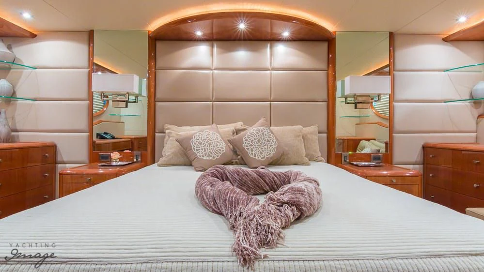 a bed with pillows aboard CHIP Yacht for Sale