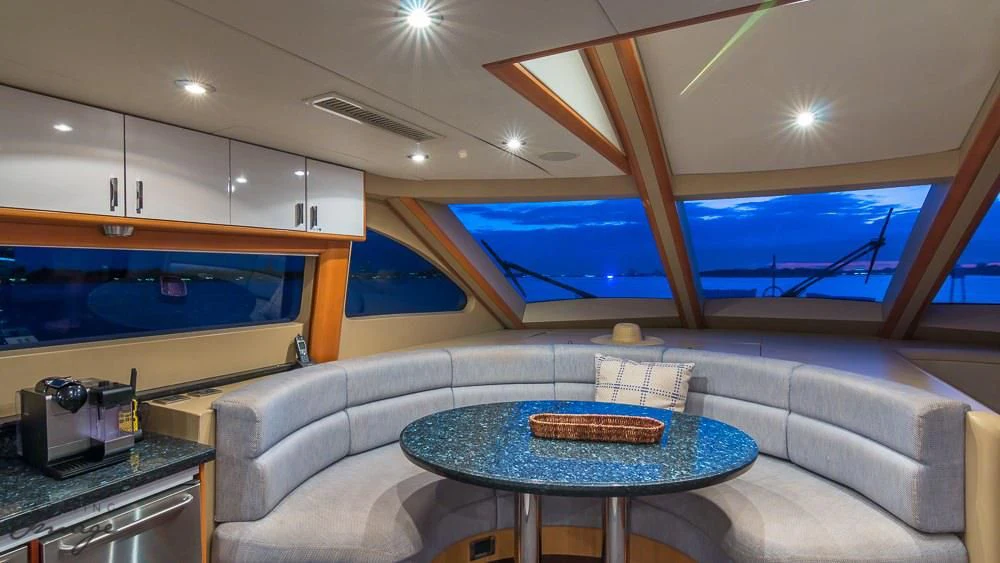 a living room with a large blue screen aboard CHIP Yacht for Sale