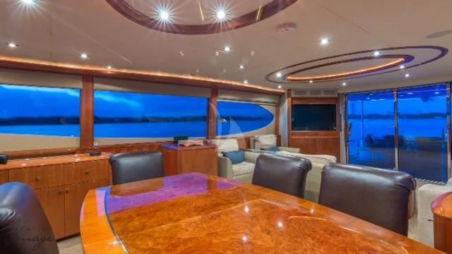 a room with a table and chairs aboard CHIP Yacht for Sale