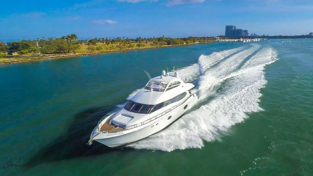 a white boat on a body of water aboard CHIP Yacht for Sale