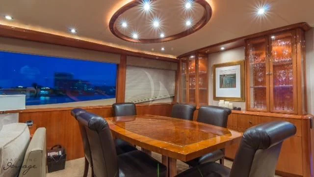a room with a table and chairs aboard CHIP Yacht for Sale