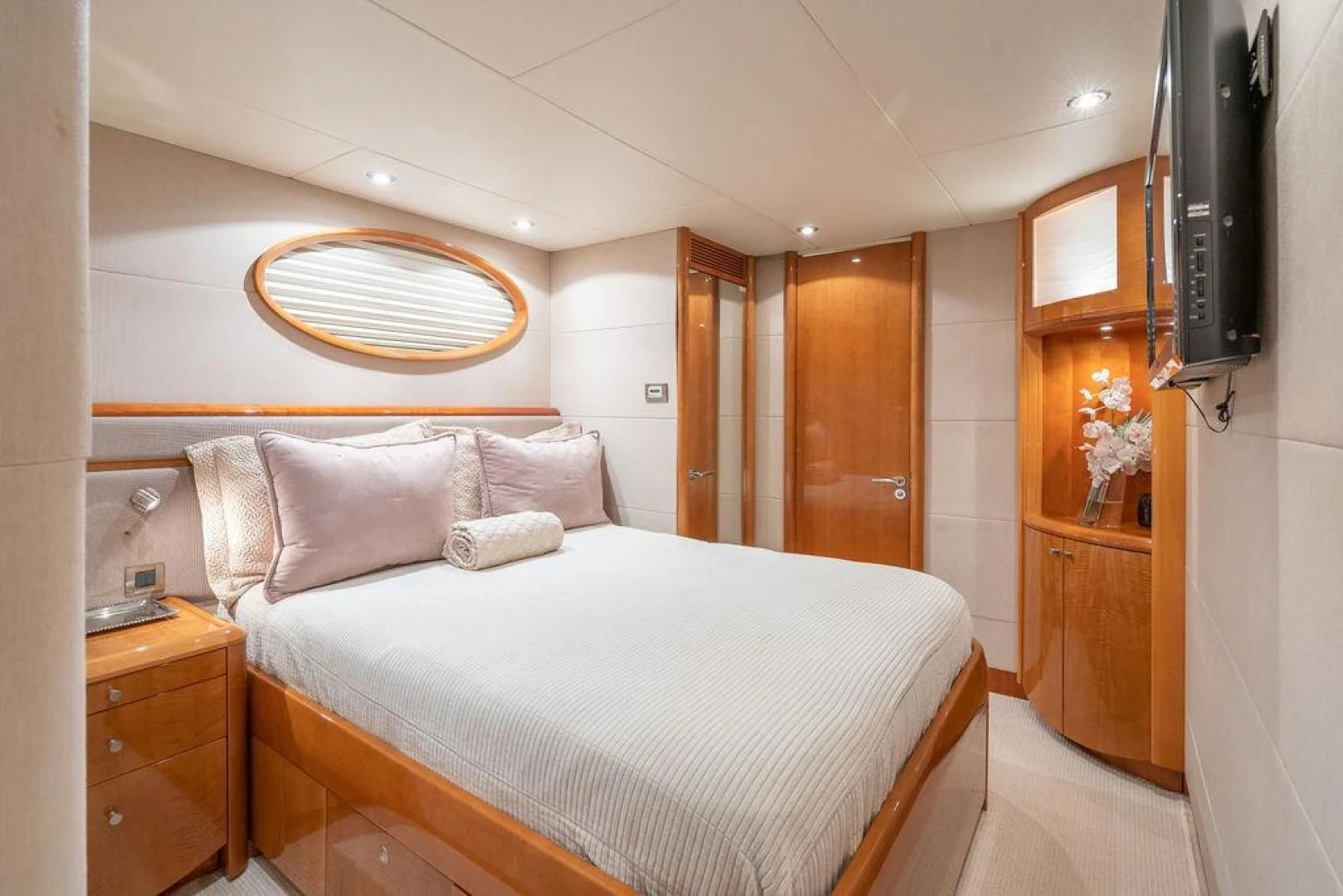 a bedroom with a bed and a dresser aboard CHIP Yacht for Sale