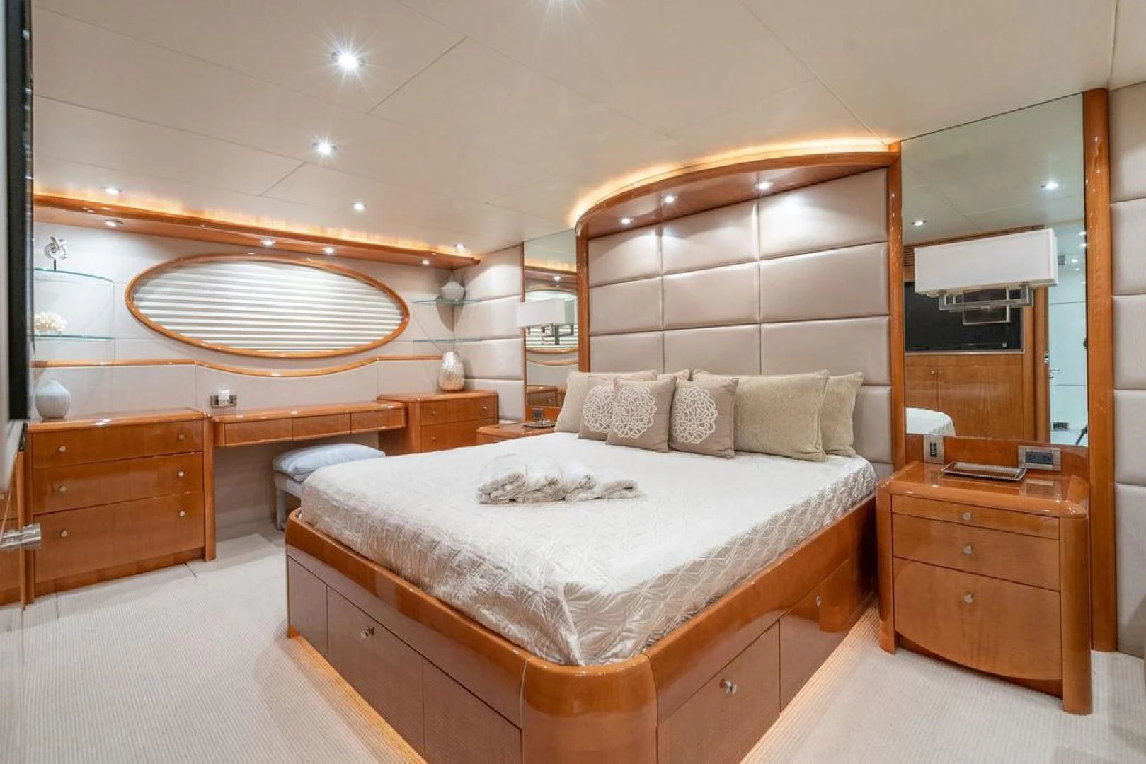 a bedroom with a bed and a mirror aboard CHIP Yacht for Sale