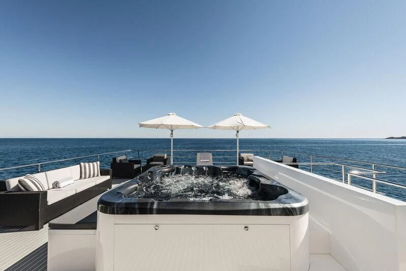 a boat with an umbrella on it aboard OURWAY Yacht for Sale