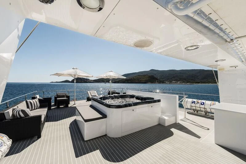 a pool with a table and chairs aboard OURWAY Yacht for Sale
