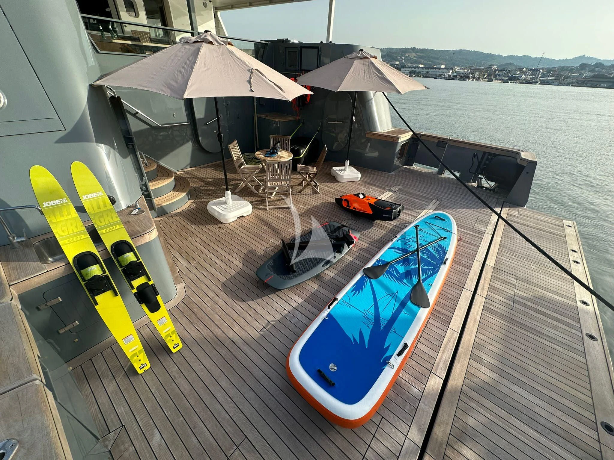 a deck with chairs and umbrellas aboard OURWAY Yacht for Sale