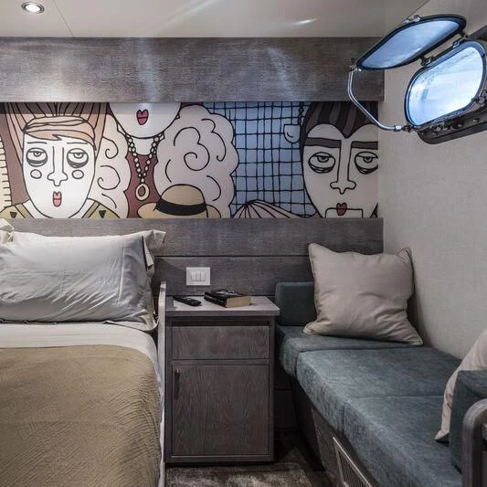 a room with a bed and a couch aboard OURWAY Yacht for Sale
