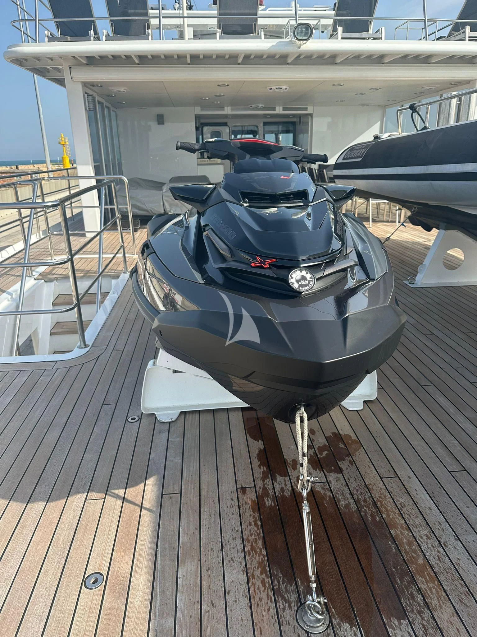 a black and silver motorcycle on a deck aboard OURWAY Yacht for Sale