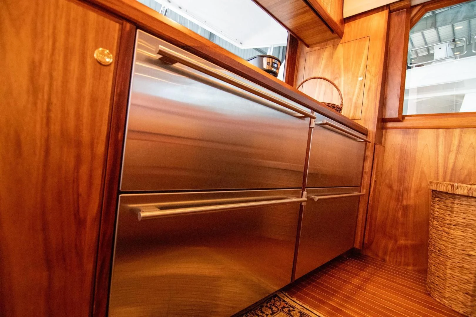a kitchen with wooden cabinets aboard CROUPIER Yacht for Sale