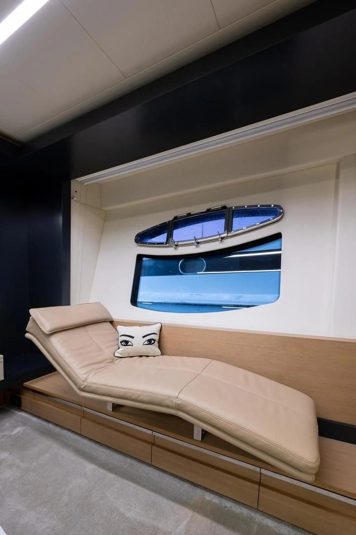 a bed with a blue window aboard CLAIMS TO FAME Yacht for Sale