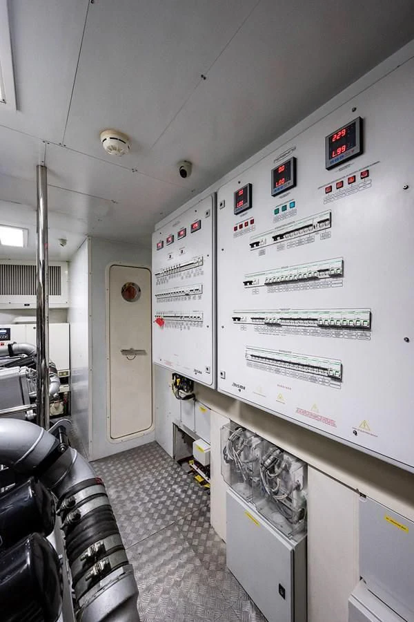 a room with a machine and chairs aboard CLAIMS TO FAME Yacht for Sale