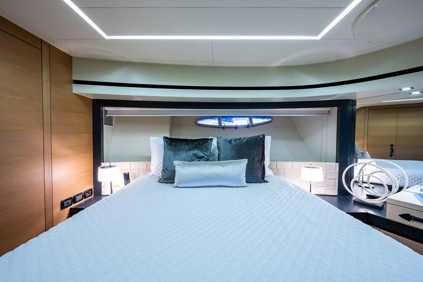 a bed with a white bed spread aboard CLAIMS TO FAME Yacht for Sale