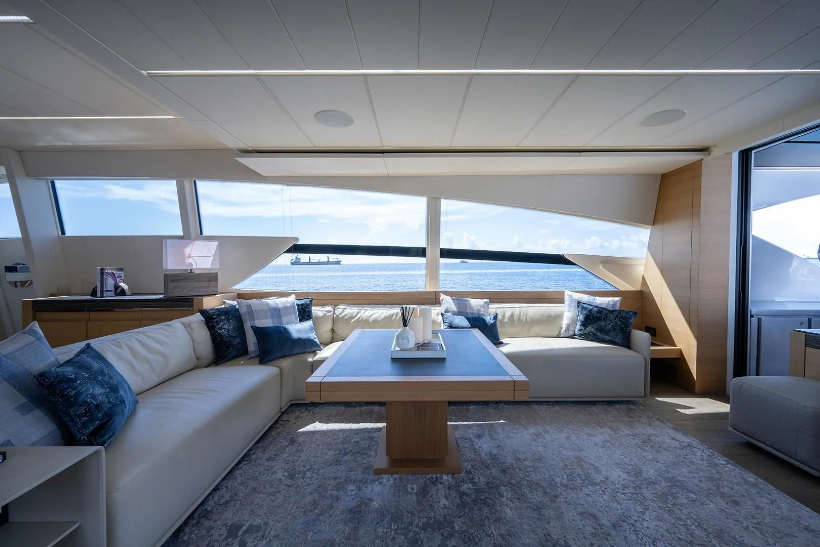 a living room with a large window aboard CLAIMS TO FAME Yacht for Sale