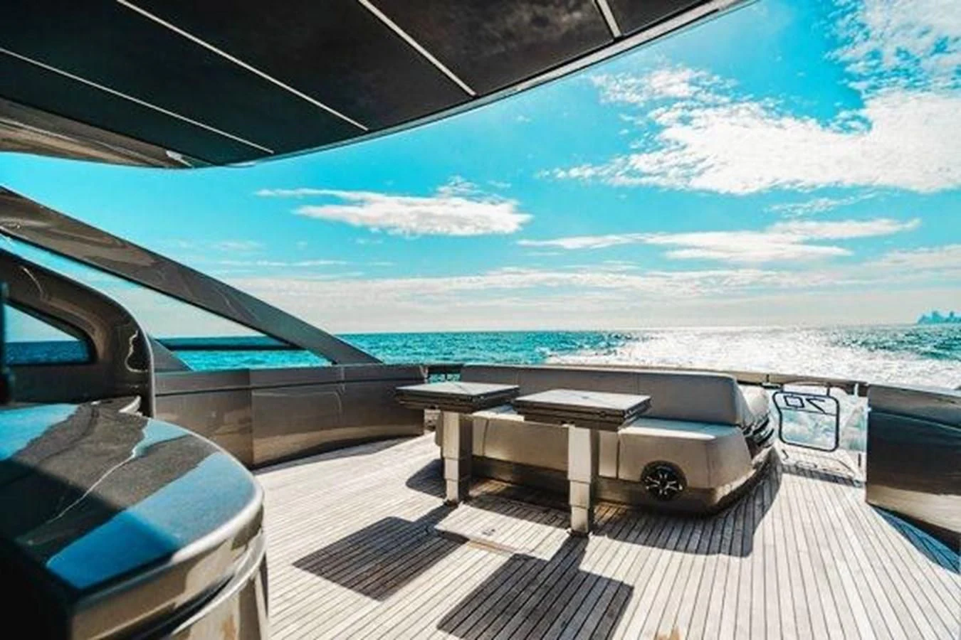 a room with a table and a view of the ocean aboard CLAIMS TO FAME Yacht for Sale
