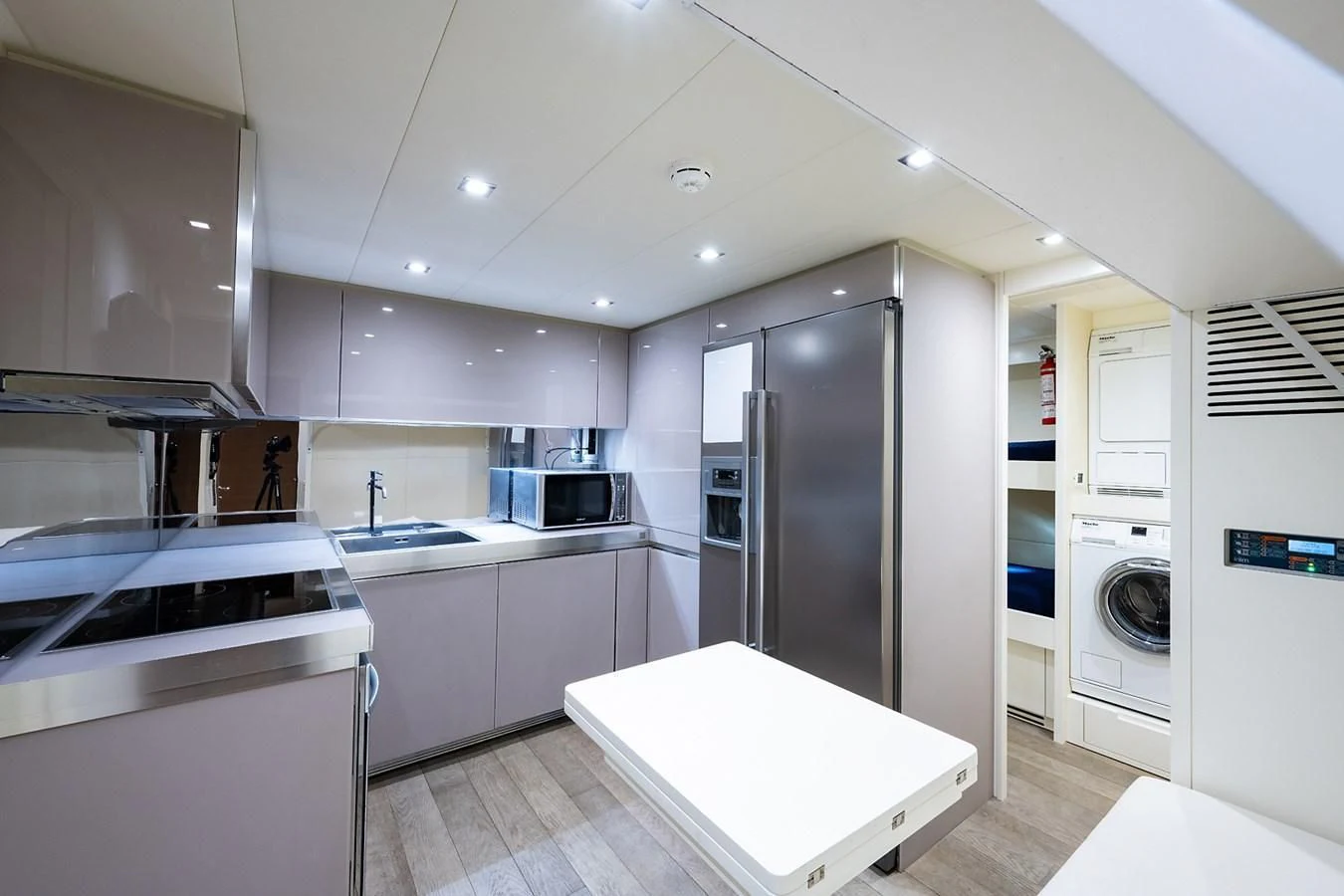 a kitchen with white appliances aboard CLAIMS TO FAME Yacht for Sale