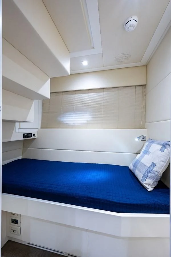 a room with a bed and a white wall aboard CLAIMS TO FAME Yacht for Sale