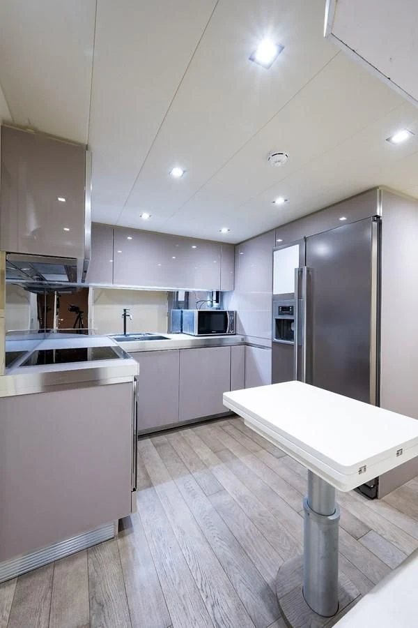 a kitchen with white cabinets aboard CLAIMS TO FAME Yacht for Sale
