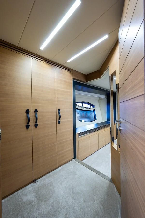 a room with wooden cabinets aboard CLAIMS TO FAME Yacht for Sale