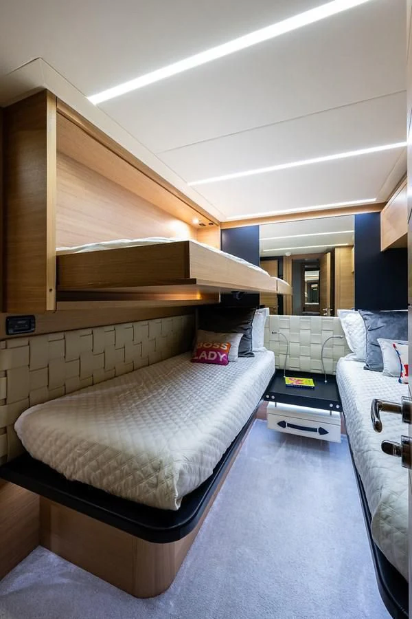a room with a bed and a desk aboard CLAIMS TO FAME Yacht for Sale