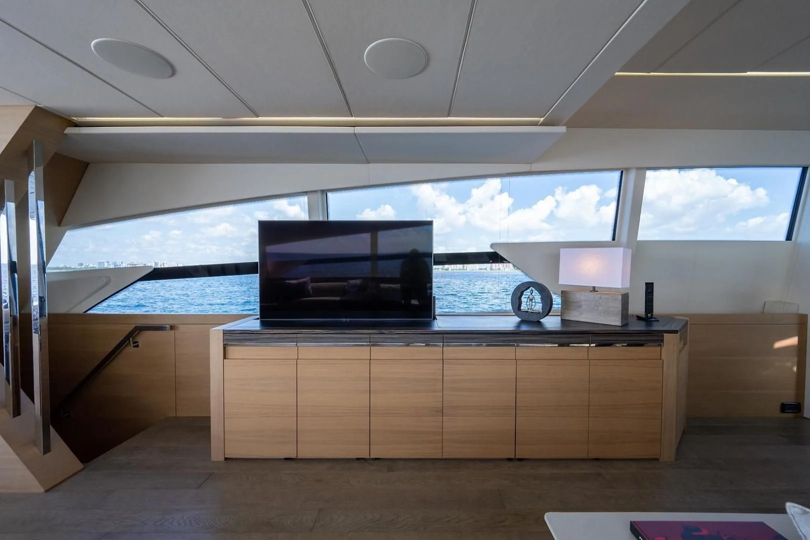 a room with a large window and a large television on the ceiling aboard CLAIMS TO FAME Yacht for Sale