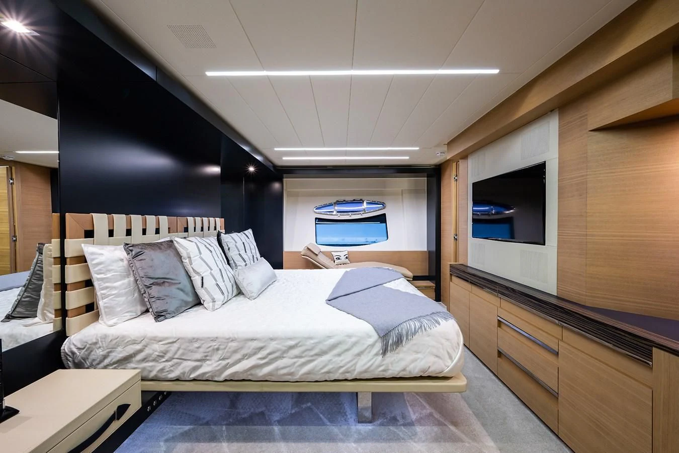 a bedroom with a bed and a desk aboard CLAIMS TO FAME Yacht for Sale