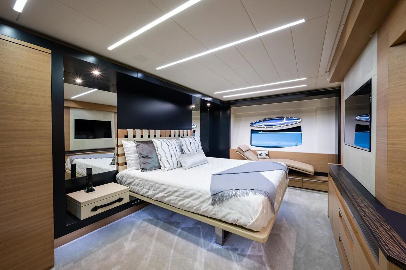 a bedroom with a bed and a large mirror aboard CLAIMS TO FAME Yacht for Sale