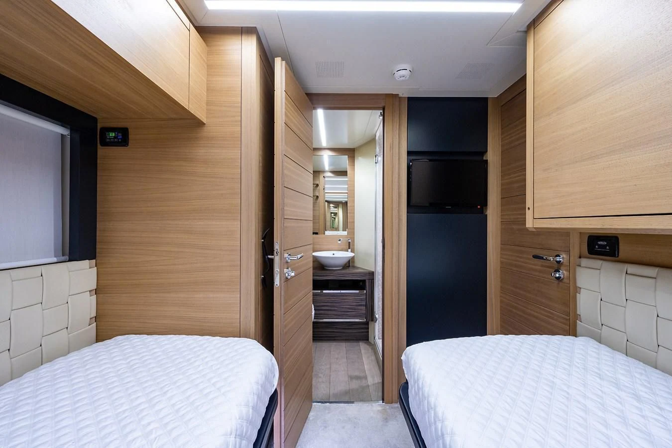 a bedroom with a bed and a sink aboard CLAIMS TO FAME Yacht for Sale
