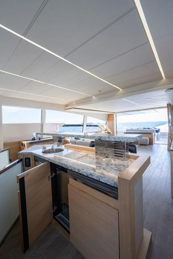 a room with a large table and chairs aboard CLAIMS TO FAME Yacht for Sale