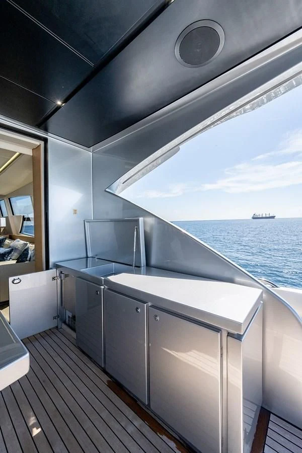 a large kitchen with a large window overlooking the ocean aboard CLAIMS TO FAME Yacht for Sale