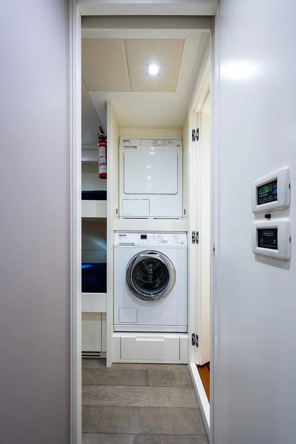 a white laundry room aboard CLAIMS TO FAME Yacht for Sale