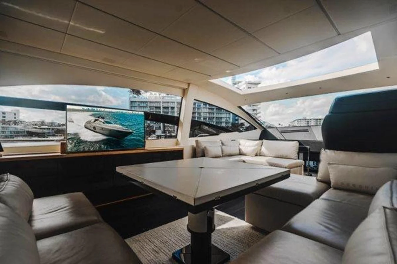 a living room with a large screen aboard CLAIMS TO FAME Yacht for Sale