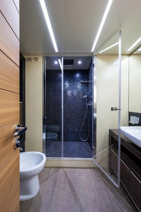 a bathroom with a glass shower aboard CLAIMS TO FAME Yacht for Sale