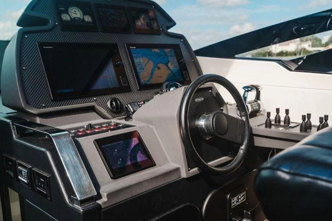 a car with a screen and a steering wheel aboard CLAIMS TO FAME Yacht for Sale