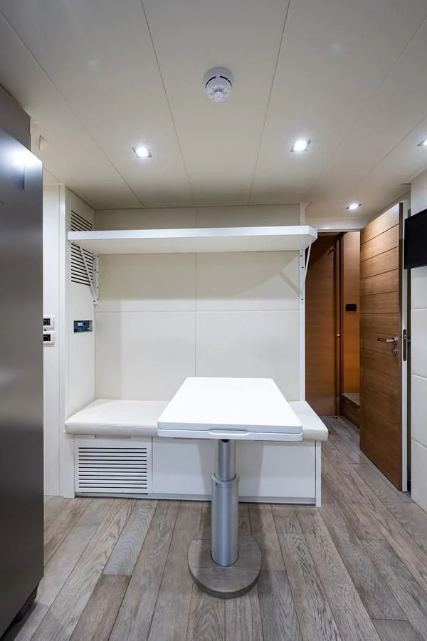 a white table in a room aboard CLAIMS TO FAME Yacht for Sale