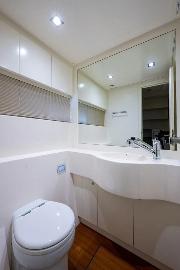 a bathroom with a toilet sink and bathtub aboard CLAIMS TO FAME Yacht for Sale