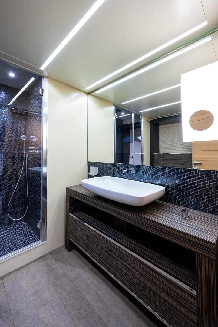 a bathroom with a large mirror aboard CLAIMS TO FAME Yacht for Sale