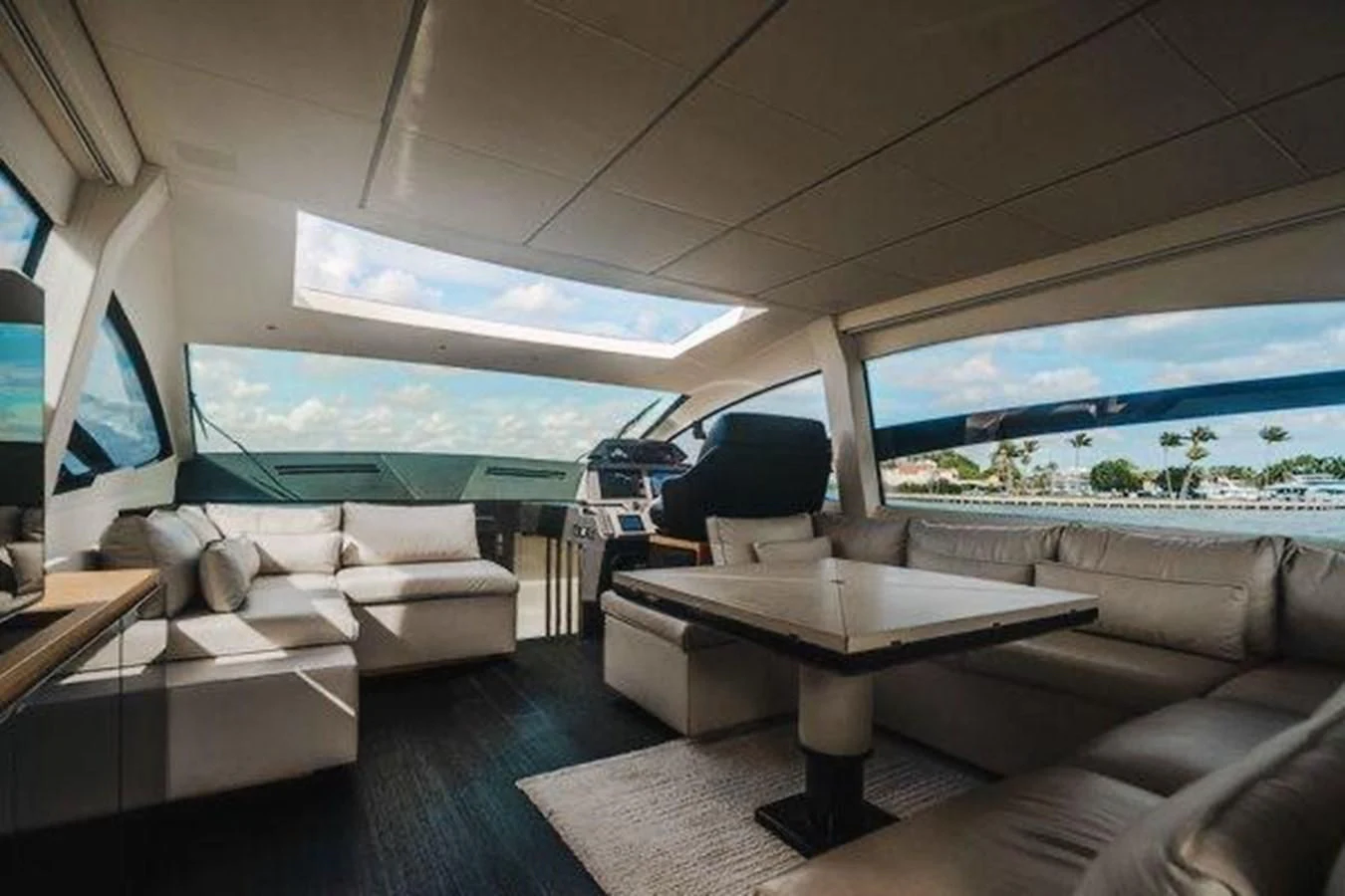 a room with a couch and a table and a television aboard CLAIMS TO FAME Yacht for Sale