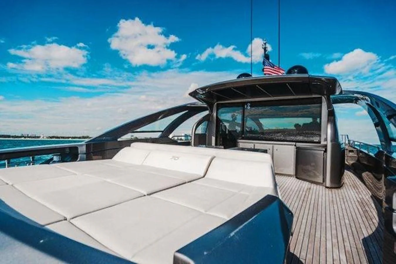 a white car on a deck aboard CLAIMS TO FAME Yacht for Sale