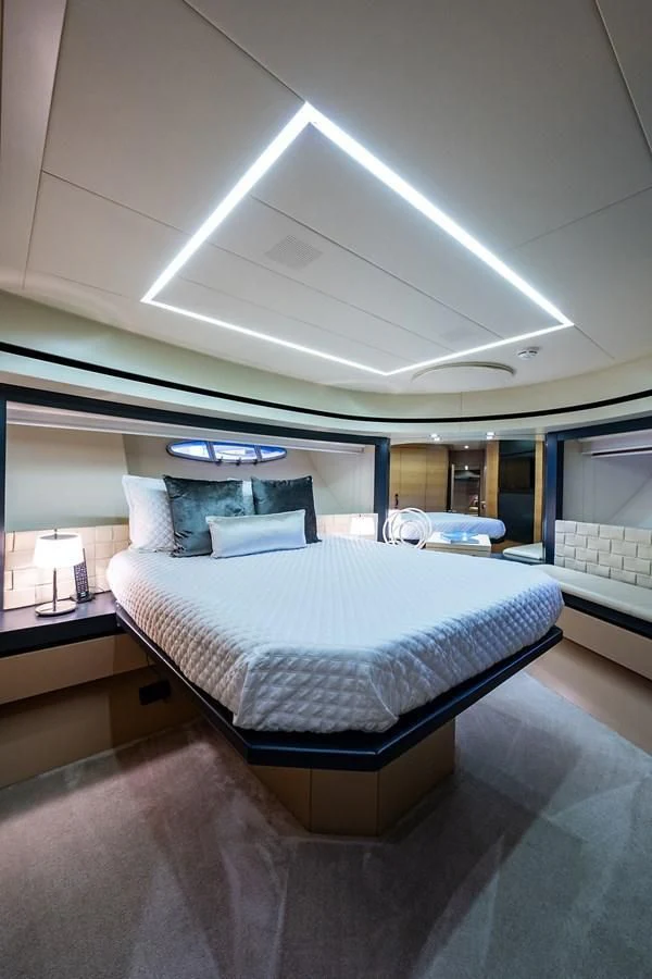 a room with a bed and a window aboard CLAIMS TO FAME Yacht for Sale