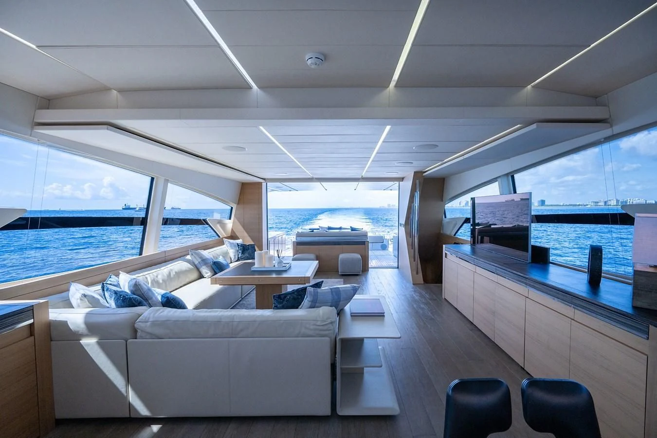 a room with a couch and a table and a large window aboard CLAIMS TO FAME Yacht for Sale