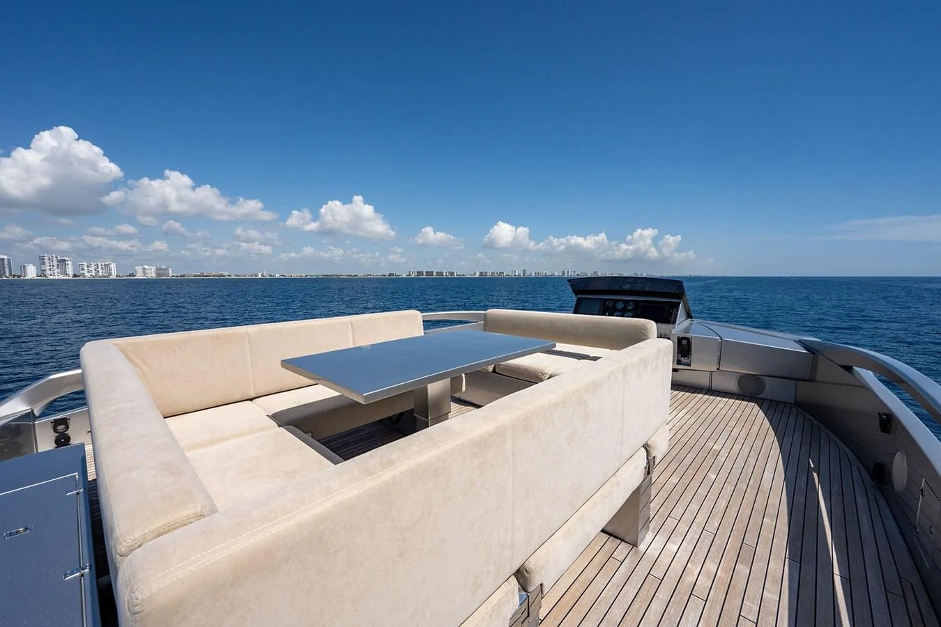 a deck with a view of a city and water aboard CLAIMS TO FAME Yacht for Sale