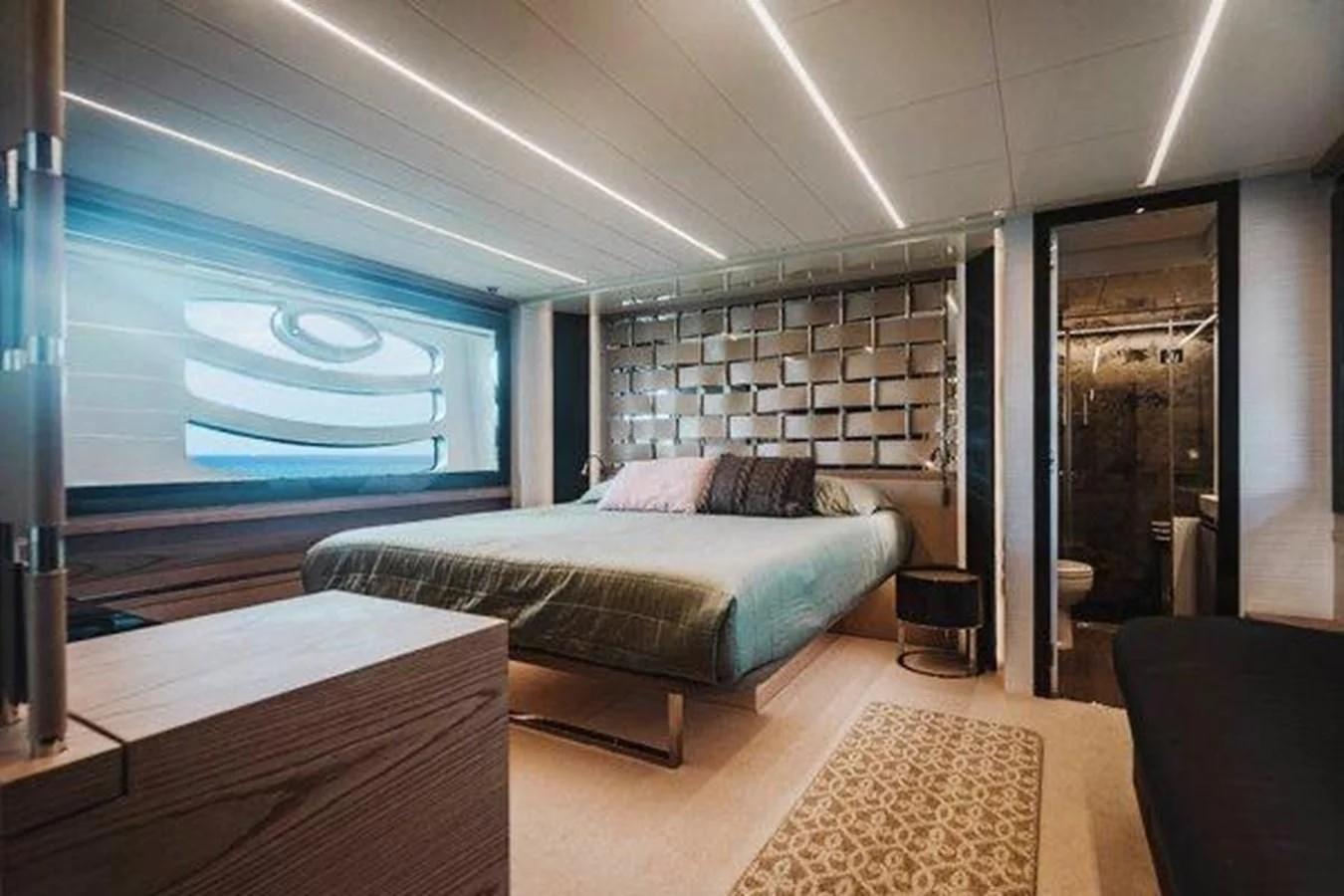 a room with a bed and a large window aboard CLAIMS TO FAME Yacht for Sale