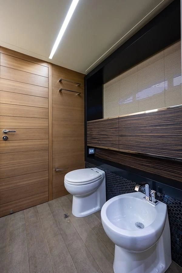 a bathroom with a toilet and sink aboard CLAIMS TO FAME Yacht for Sale