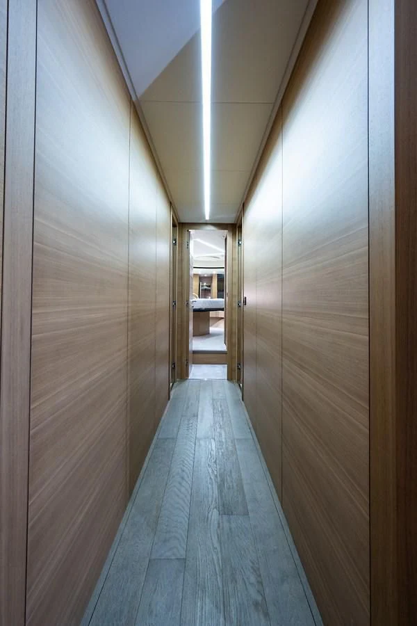 a hallway with a door aboard CLAIMS TO FAME Yacht for Sale