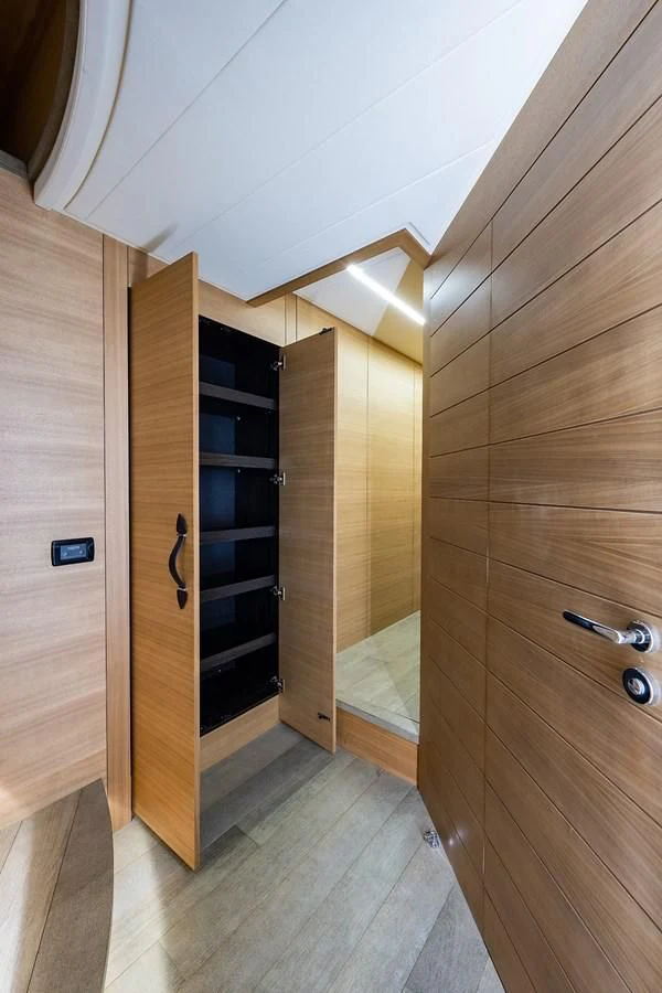 a room with a wood door and a glass wall aboard CLAIMS TO FAME Yacht for Sale