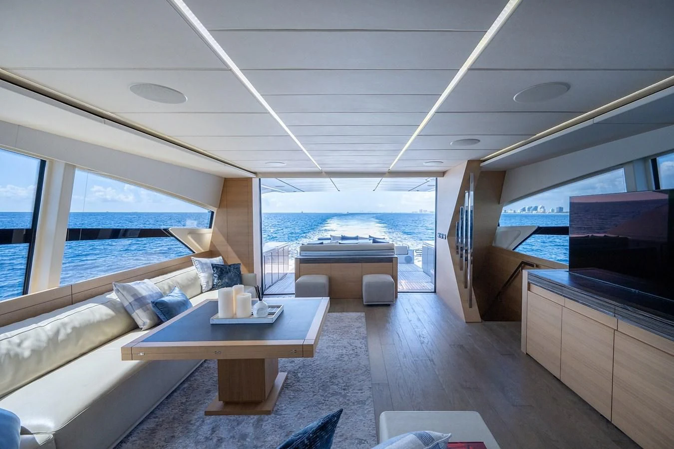 a room with a table and a tv aboard CLAIMS TO FAME Yacht for Sale